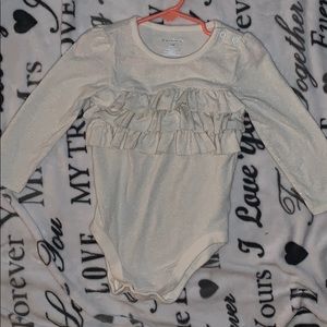 Stretchy onesie with ruffles and glitter strips!